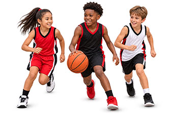 Three children smiling while playing youth basketball